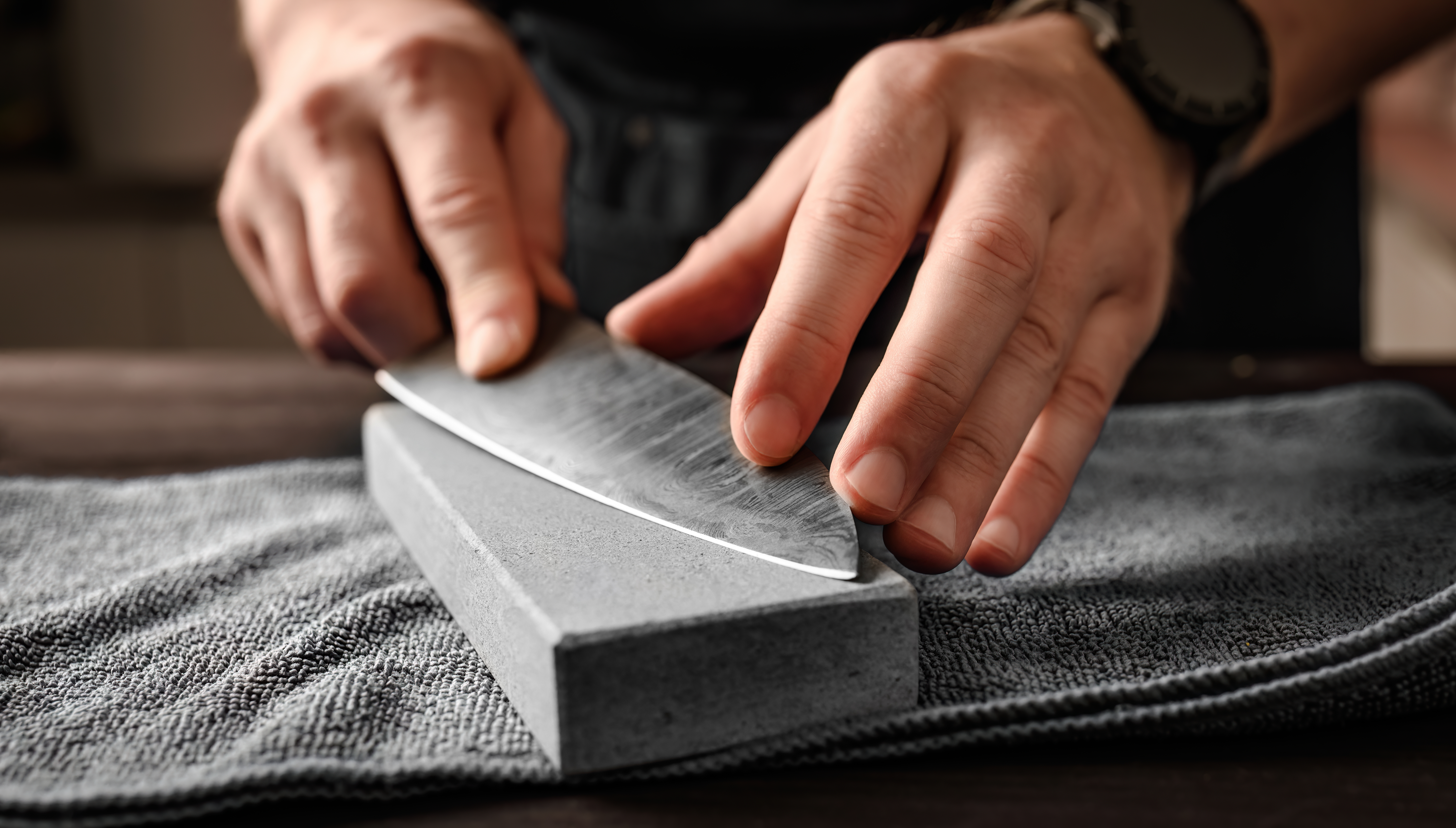 Close-up of a knife being sharpened on a Japanese whetstone